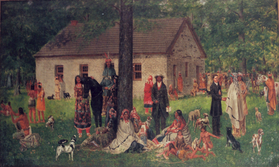 Painting of the Wyandot Mission in Ohio. Native Americans sit in the foreground with the stone church behind them.